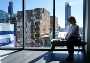 amanda on bend with view of city