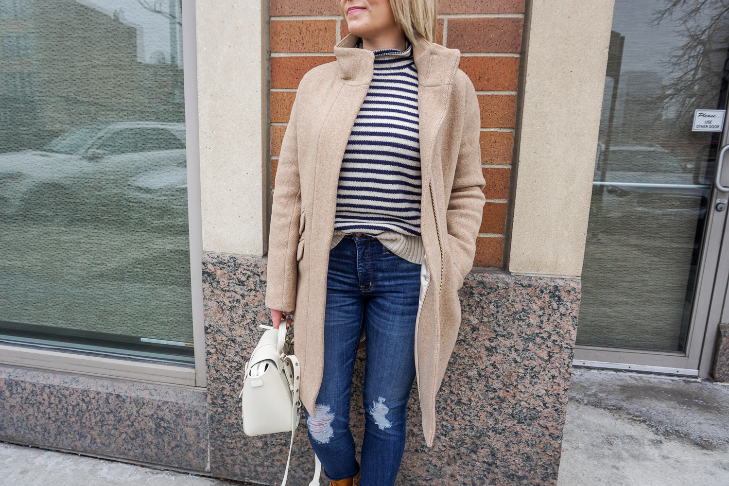 striped sweater and camel coat