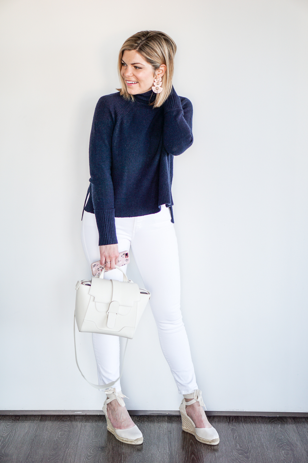 navy turtleneck and white jeans