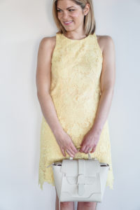 white bag and yellow lace dress